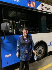 Picture of Michelle Boatman, Passenger Revenue 3rd Shift Supervisor in front of a MetroBus. 