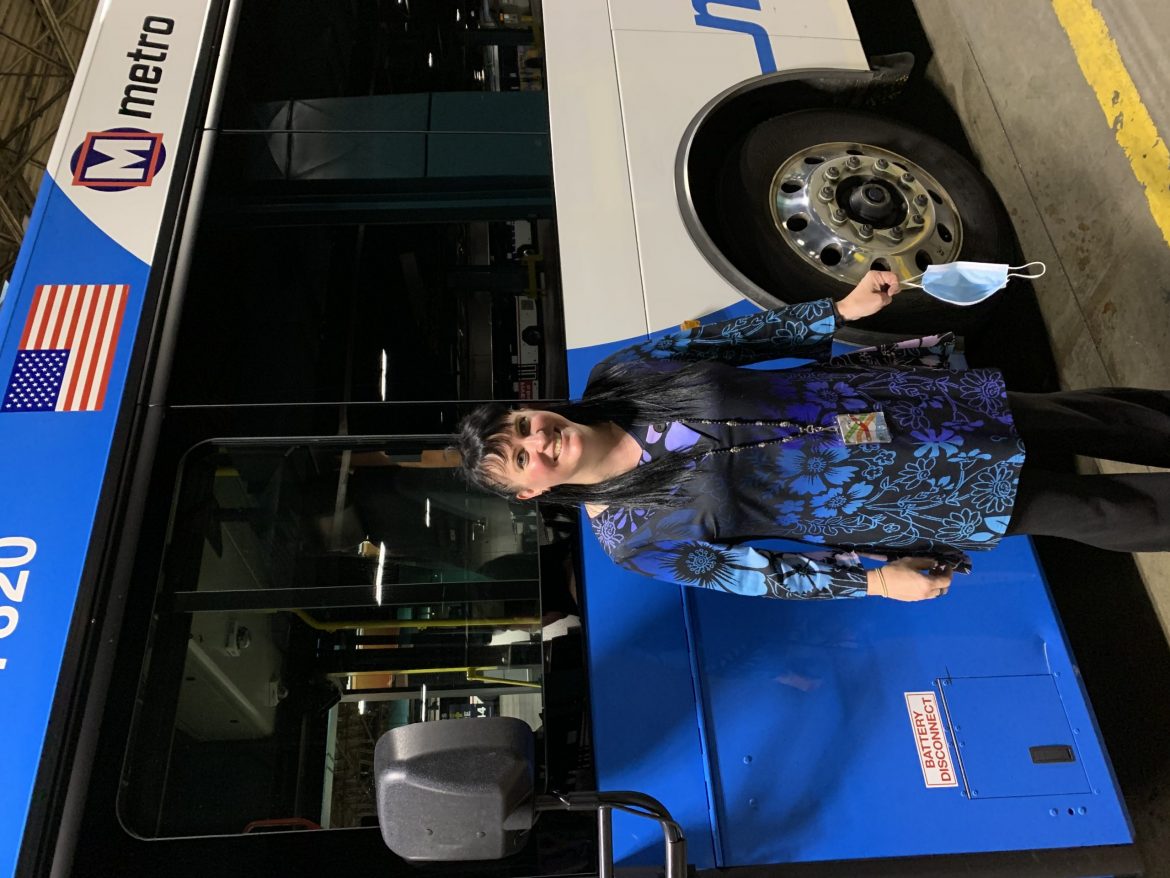 Picture of Michelle Boatman, Passenger Revenue 3rd Shift Supervisor in front of a MetroBus.