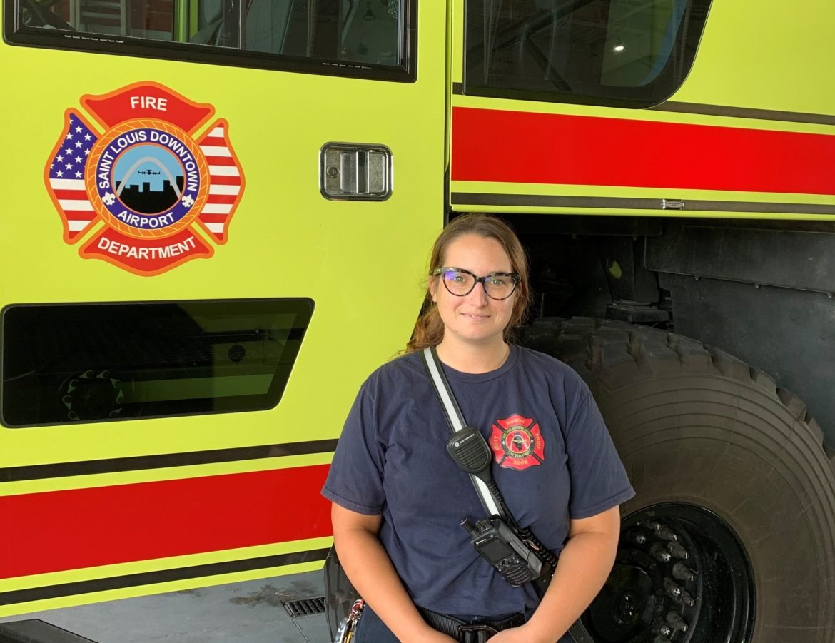 Gina Wallace, Airport Operations Specialist at the St. Louis Downtown Airport poses in front of the airport's fire truck.