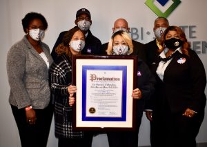 Group photo of Metro management, union representatives and Metro Transit operators being presented with a proclamation for Transit Driver Day