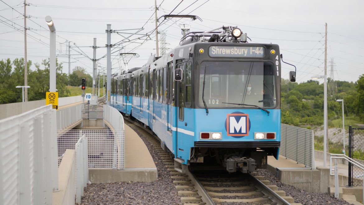 A blue MetroLink train approaches Shrewsbury.
